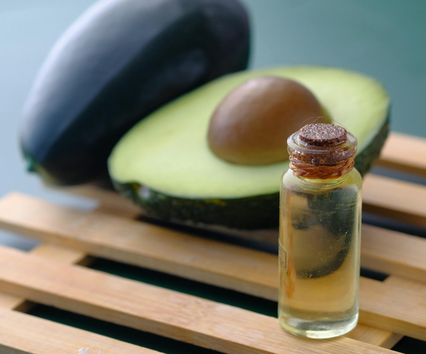 Ulje od avokada: presečeni avokado i flašica ulja